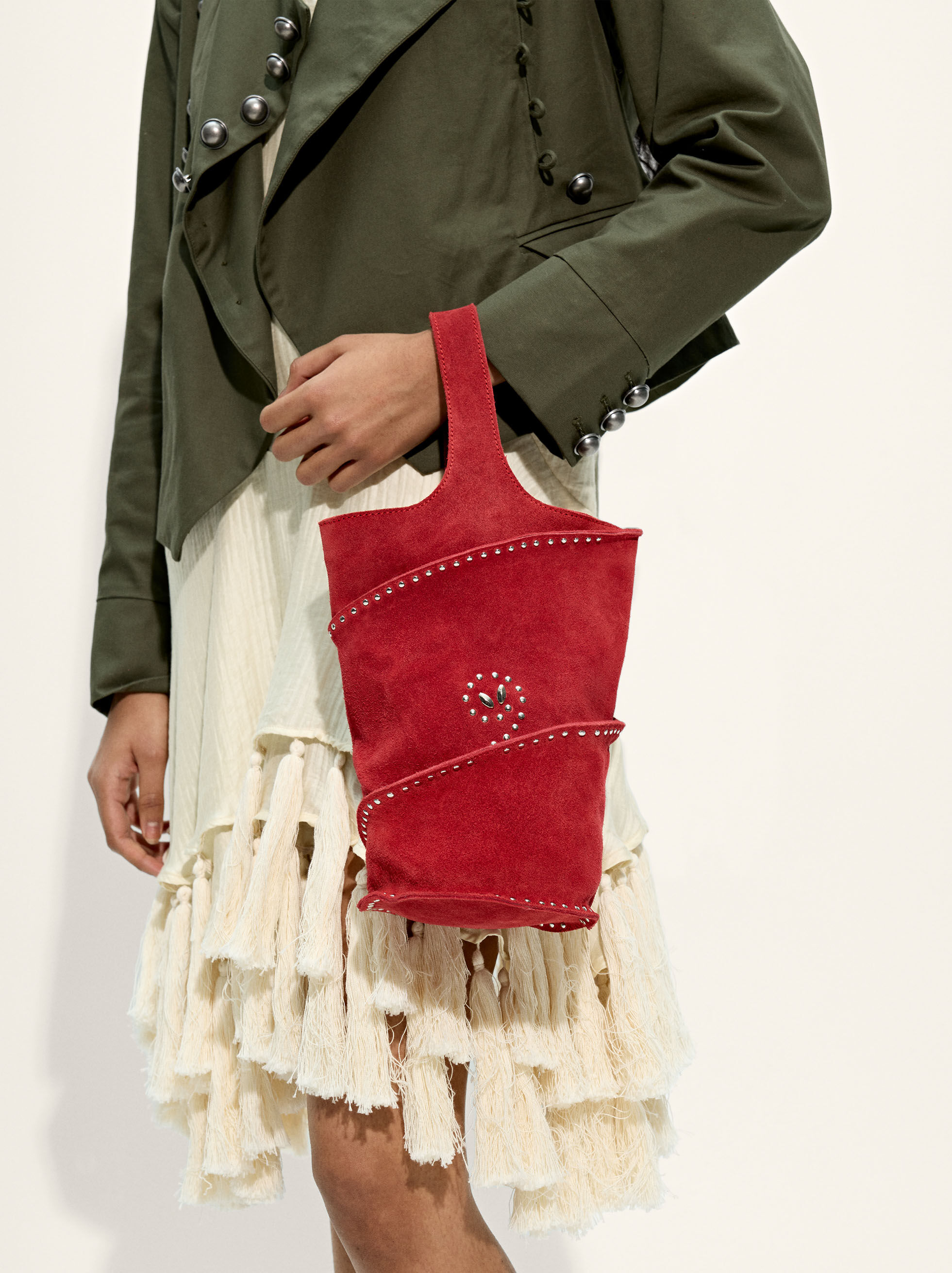 Cylindrical handbag made of leather with studs