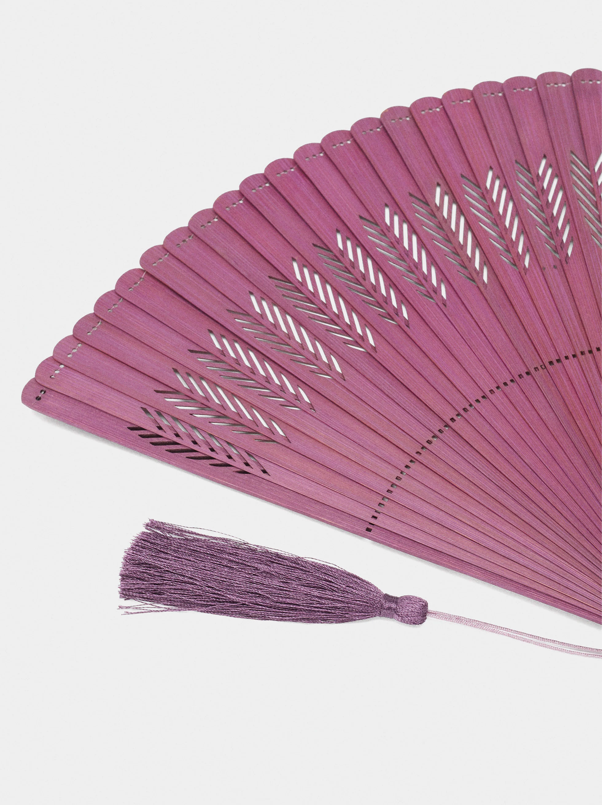 Perforated fan with tassel